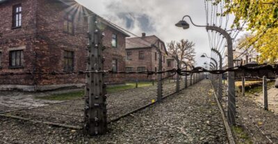 Kraków: Auschwitz-Birkenau & Salt Mine Full-Day Guided Tour - Auschwitz I: Gate, Barracks, and the Meaning of the Layout